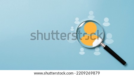 Yellow human icon inside of magnifier glass among white icons for customer focus and customer relation management or CRM concept.