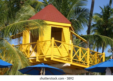 yellow hut beneath palm trees