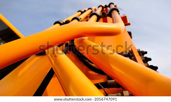 Yellow hydraulic hose. Metal
hydraulic hose system on backhoe arms or heavy equipment. close
focus