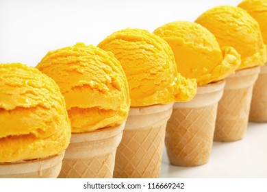 Yellow Ice Cream Cones Arranged In A Row
