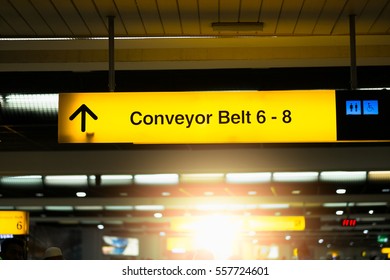 Yellow Illuminated Sign At Airport With Conveyor Belt  For Departing Flights