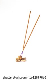 yellow incense sticks in a wooden stand isolated on a white background