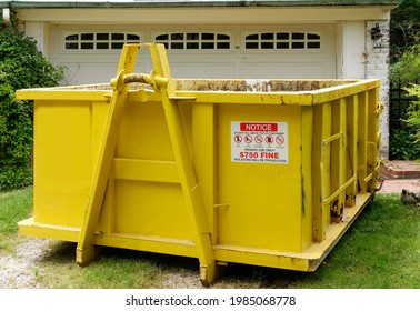 Yellow Industrial Dumpster In Residential Neighborhood.