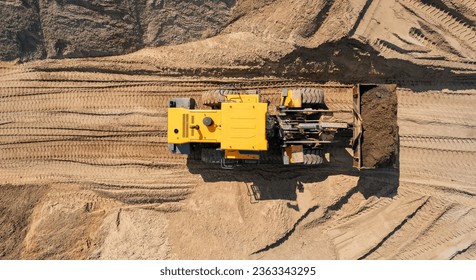 Yellow Industrial excavator working on sand quarry. Aerial top view open pit mine industry concept. - Powered by Shutterstock