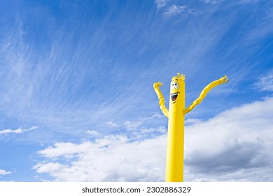 Yellow Inflatable Doll Blowing Wind with happy face. - Shutterstock ID 2302886329