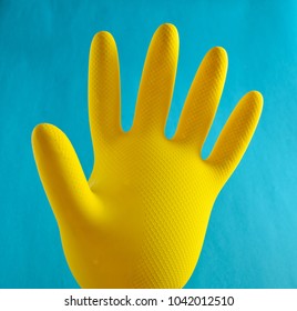 Yellow Inflated Rubber Glove For Cleaning On A Blue Background
