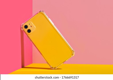 Yellow iPhone 11 in clear phone case, bright and colorful phone case mock up 