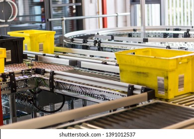 Yellow Item Totes Going Round On A Conveyor Within An E Commerce Distribution Centre