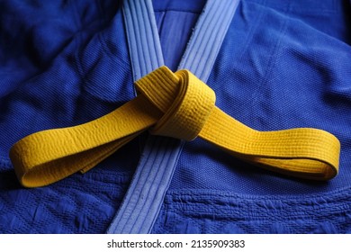 Yellow judo belt on a blue kimono. Colors of the Ukrainian flag - Shutterstock ID 2135909383