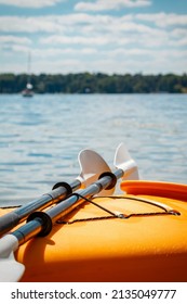 Yellow Kayak With Black And White Paddles