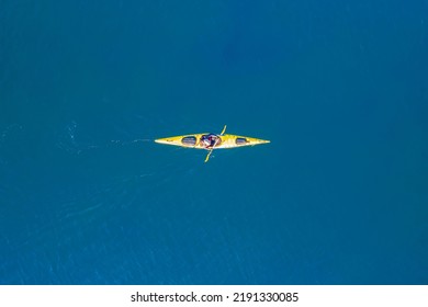 Yellow Kayak Rowers On Blue Turquoise Water Sea, Sunny Day. Concept Extreme Sport, Aerial Top View.