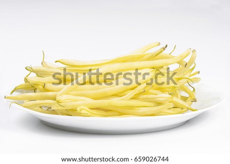 Yellow kidney beans on a white plate isolated on white background