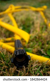 A Yellow Kinked Garden Hose.