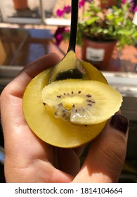 Yellow Kiwi Being Eaten With A Spoon