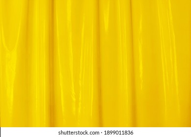 Yellow latex, soft folds, background for your design. Latex, lacquer varnish wave