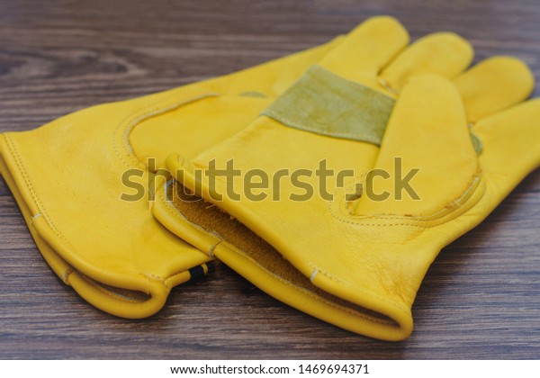 Yellow leather gloves for hard work,\
motorsport, building, car\
dealerships.