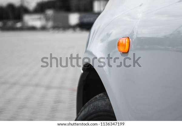 yellow light turn\
signal on a silver car