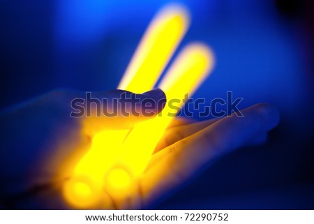 yellow lightsticks in hand