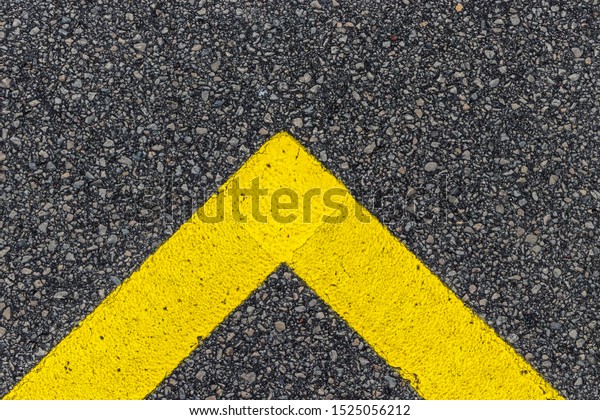 Yellow line. Band of
yellow reflective paint on a black asphalt. Yellow line on road
texture. Road marking.