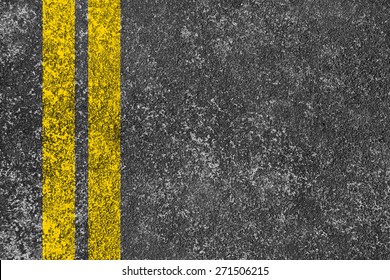 Yellow lines is painted on the asphalt road.