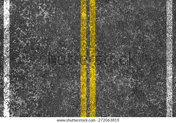Yellow lines is\
painted on the asphalt\
road.