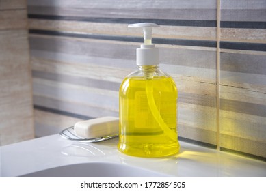 Yellow Liquid Soap Next To Hand Soap On The Bathroom Sink.