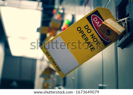 Yellow Lock out & Tag out for Lock station,machine - specific or switch gear roomd evices and safety first point, Cyber security or safety industrial concept.                      