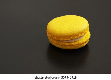 Yellow Macaron Cake On A Black Table