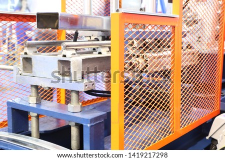 yellow machine safety Guard for stainless steel cold rolling machine ; protect people from danger ; industrial equipment background