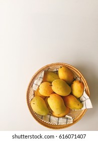 Yellow mango in a basket On a white background.