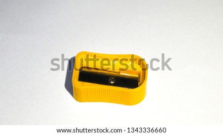Yellow manual pencil sharpner isolated on white background