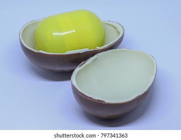 Yellow Maxi Kinder Egg Toy Box And Two Side Of Chocolate Shells.