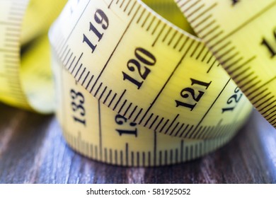 Yellow measuring tape of the tailor. Selective focus.
