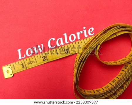 Yellow measuring tape with the word Low Calorie on a red background  