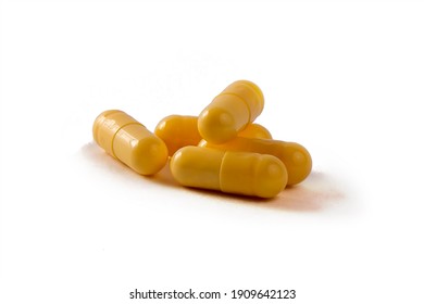 yellow medicine capsules with medicine , isolated on a white background