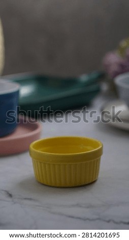 yellow mini ramekin at the front of varius ceramic