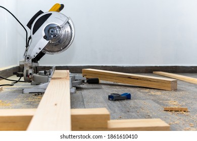 Yellow Miter Saw Cutting Wood