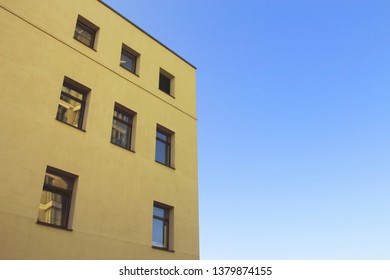 Yellow Modern Architecture Building Top Corner On Blue Sky Background 