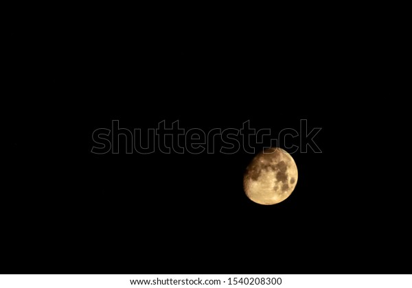 Yellow Moon phase in\
focus