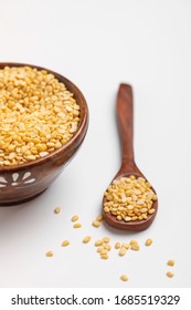 Yellow Moong Mung Dal Lentil Pulse Bean In Wooden And Spoon Bowl On White Background