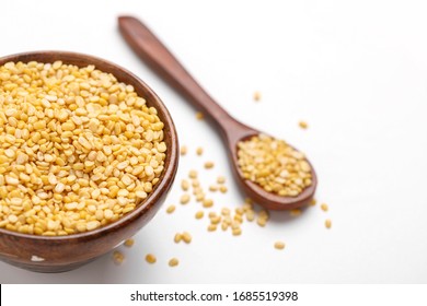 Yellow Moong Mung Dal Lentil Pulse Bean In Wooden And Spoon Bowl On White Background