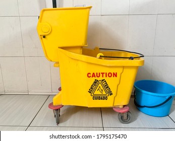 Yellow Mop Bucket For Cleaning Supplies In Toilet