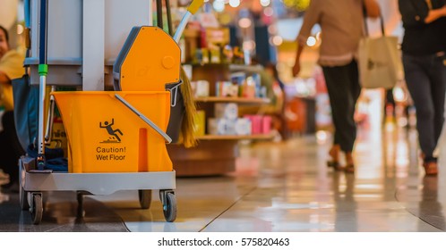 Yellow Mop Bucket Floor Cleaning Equipment And Mops In Shopping Mall And Department Store Vintage Style Picture.