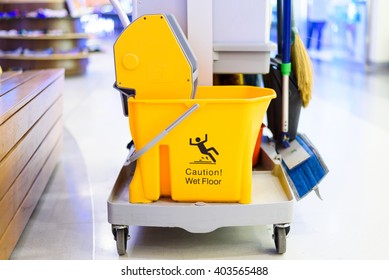 Yellow Mop Bucket And Set Of Cleaning Equipment Department Store