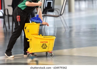 Yellow Mop Bucket And Set Of Cleaning Equipment