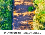 Yellow muddy waters of Macquarie river in Dubbo town – aerial 4k top down.
