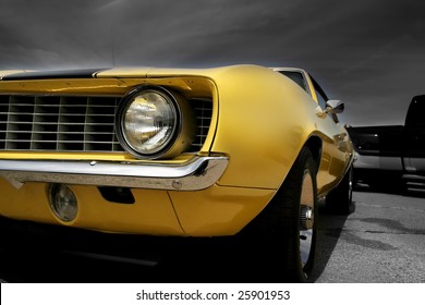 Yellow Muscle Car Against Dark Cloudy Background