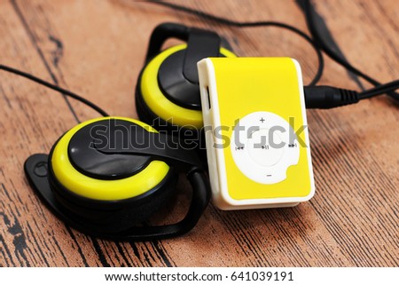 Yellow music player and beautiful overhead headphones, lux
