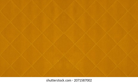 Yellow mustard colored seamless natural cotton linen textile fabric texture pattern, with diamond quilted, rhombic stiching.  stitched background