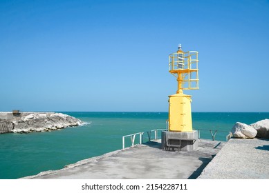 Yellow Navigational Aid Beacon With Solar Battery On Pier